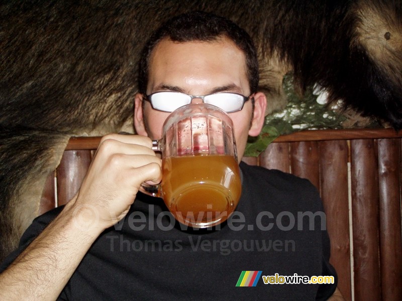 Cédric drinking a glass of warm beer