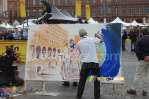 Animation au Village Départ : André Fuzin crée un tableau et Marc Vinco sur son VTT Trial (974x)
